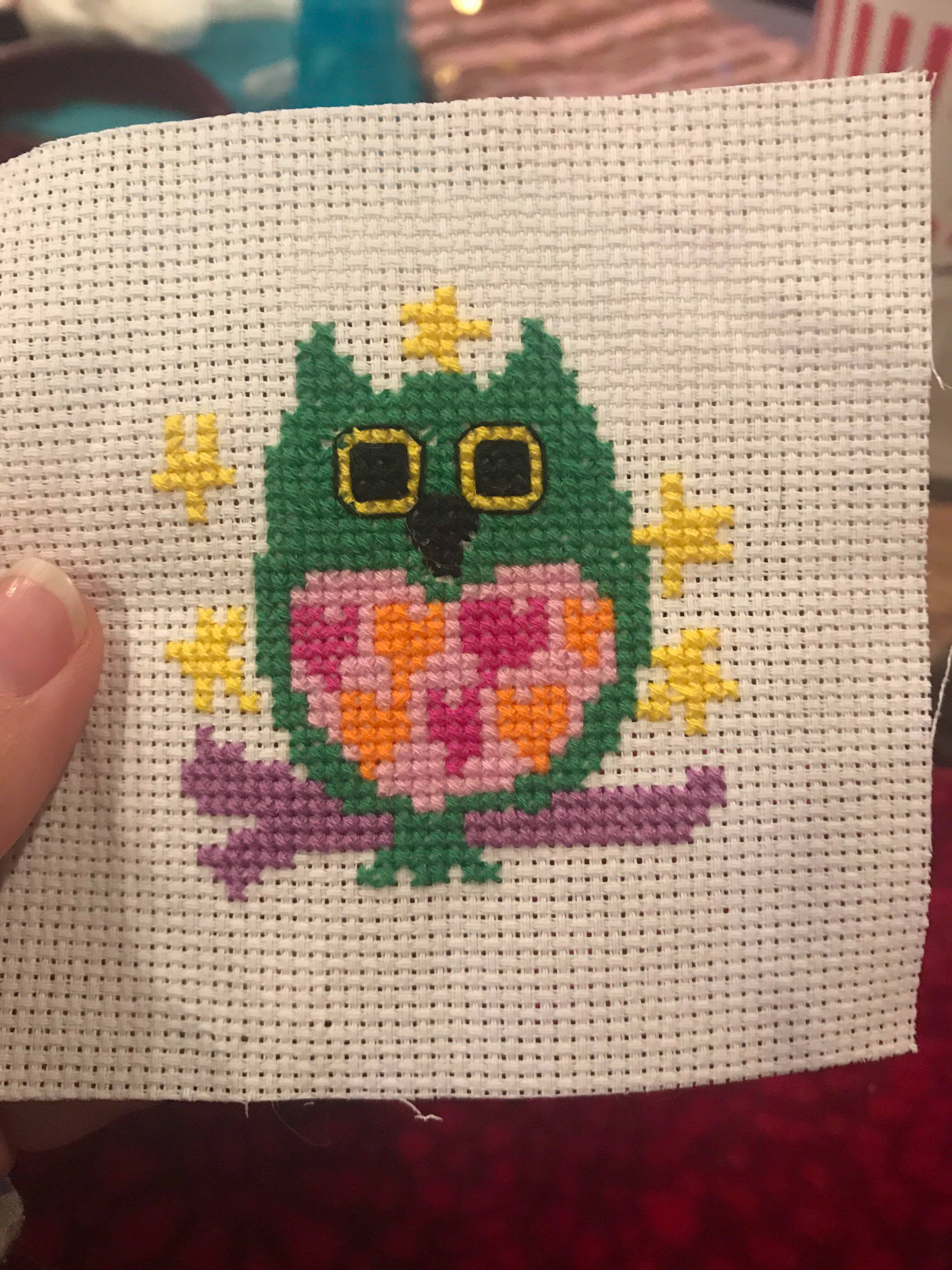 A tiny cross stitch of an owl